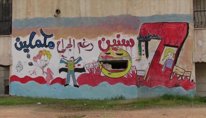 بالجرافيتي.. "الأسمر" يوثّق معاناة السوريين على الجدران المدمّرة