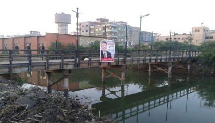 بالصور : الثوار يرفعون صورة الرئيس مرسي أعلى كوبرى المعلمين بالمنزلة دقهلية