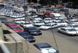 سائقو "التاكسي الأبيض" يقطعون شارع التحرير احتجاجا على زيادة أسعار الوقود