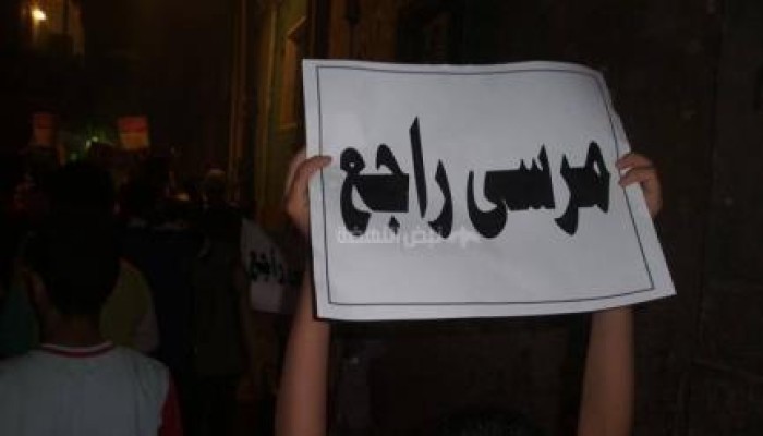 في مسيرة ليلية ثوار أوسيم يرفعون لافتات "مرسي راجع"